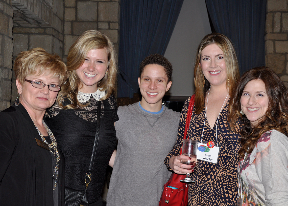 Katherine Pryor poses with four recent alums