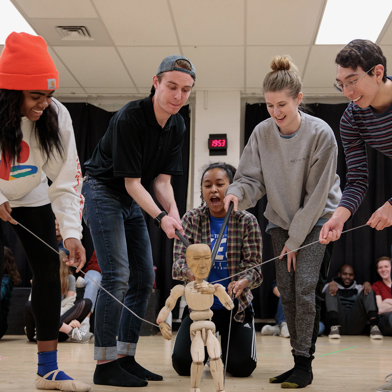 Five students work together to animate a puppet in a rehearsal for the University Theatre production of "Sycorax."